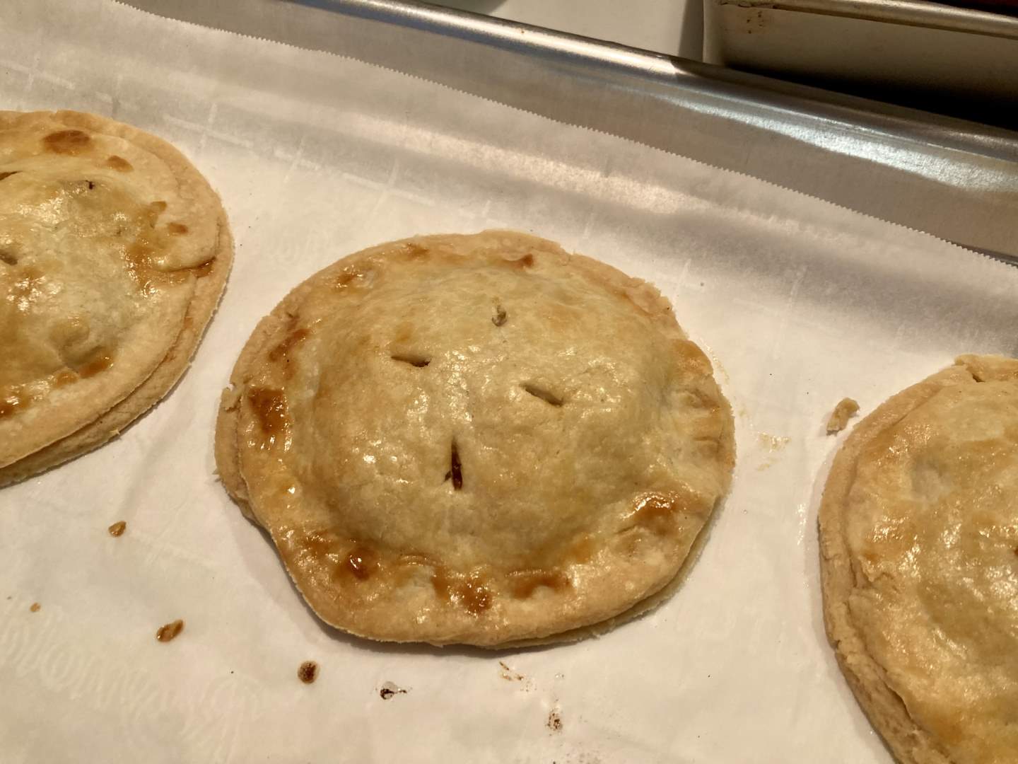 the pork pies cooked on the baking sheet