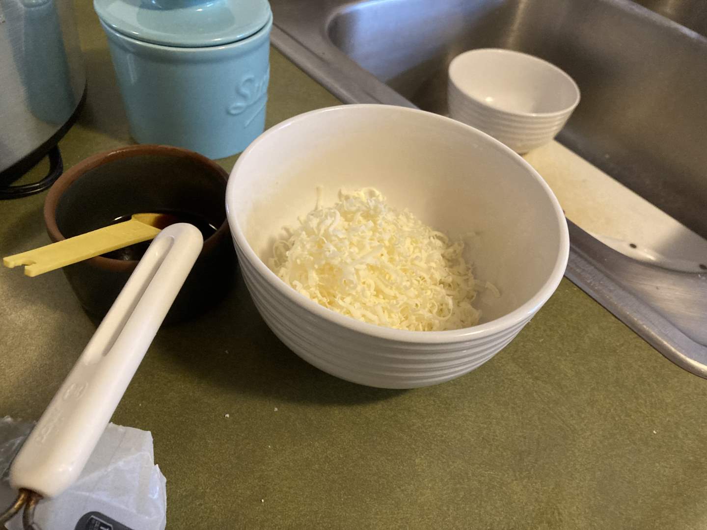 a bowl of shredded sharp cheddar
