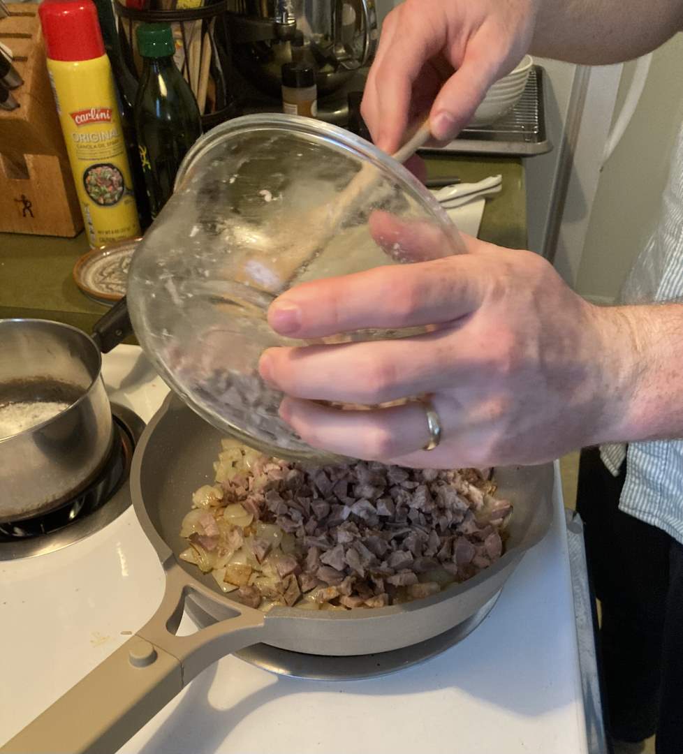 Ben mixing minced pork and onions