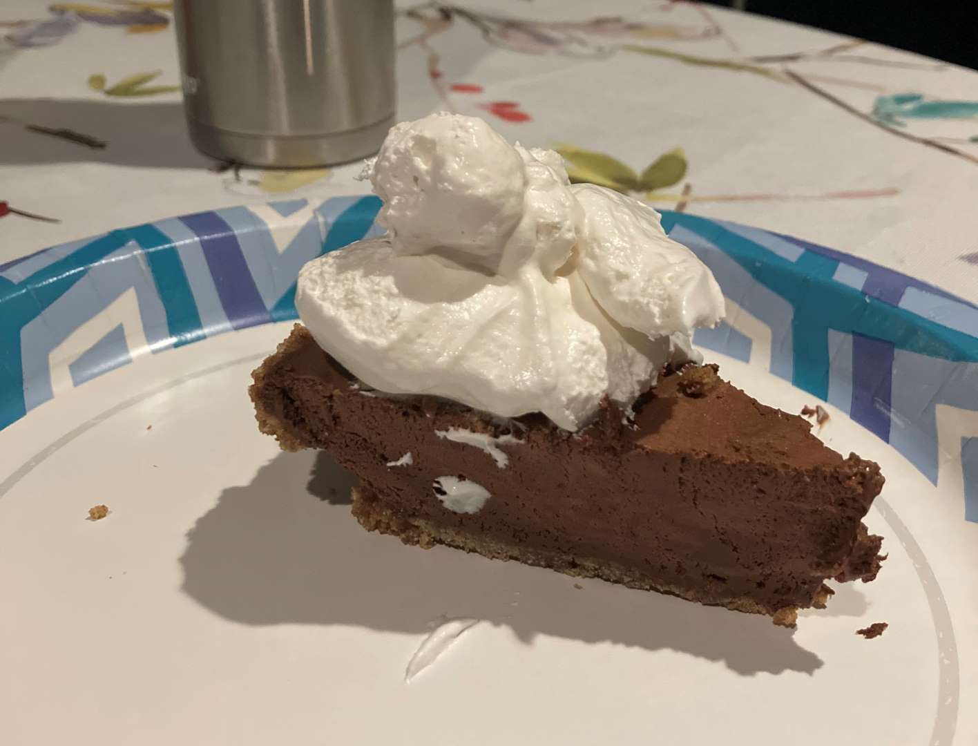a slice of chocolate icebox pie sitting on a paper plate